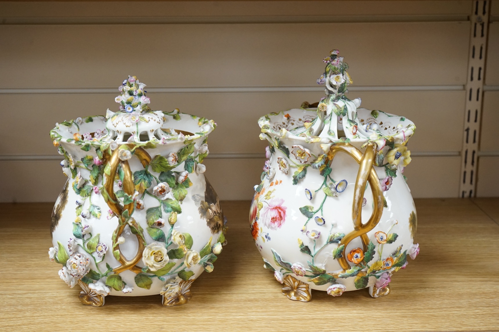 A pair of Rockingham two handled pot pourri vases and covers, c.1830-42, the first painted with two named views near Lyme, Dorsetshire and Stockly Bridge’, The second with an unnamed view of a monument by a lake, the rev